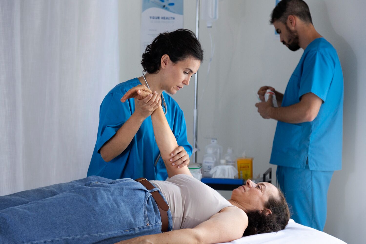 Healthcare professionals performing minimally invasive pain management procedure, illustrating BlueCross BlueShield coverage options for nerve block injections, joint injections, and other treatments.