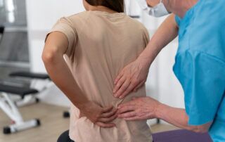 Chiropractor adjusting a patient’s back, demonstrating the importance of recognizing back pain causes and seeking professional treatment for relief.