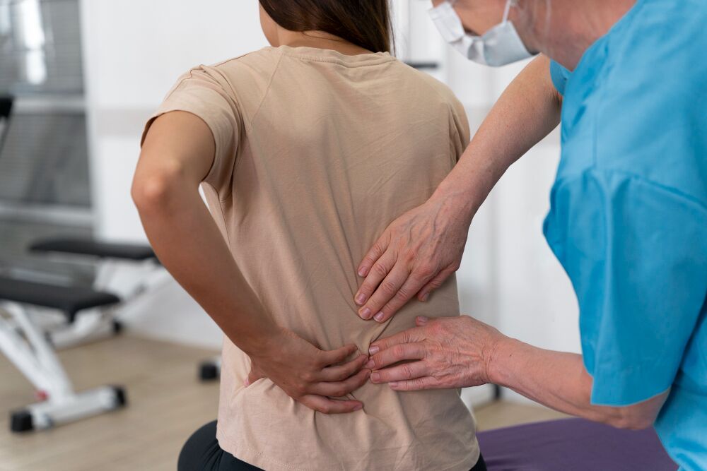 Chiropractor adjusting a patient’s back, demonstrating the importance of recognizing back pain causes and seeking professional treatment for relief.