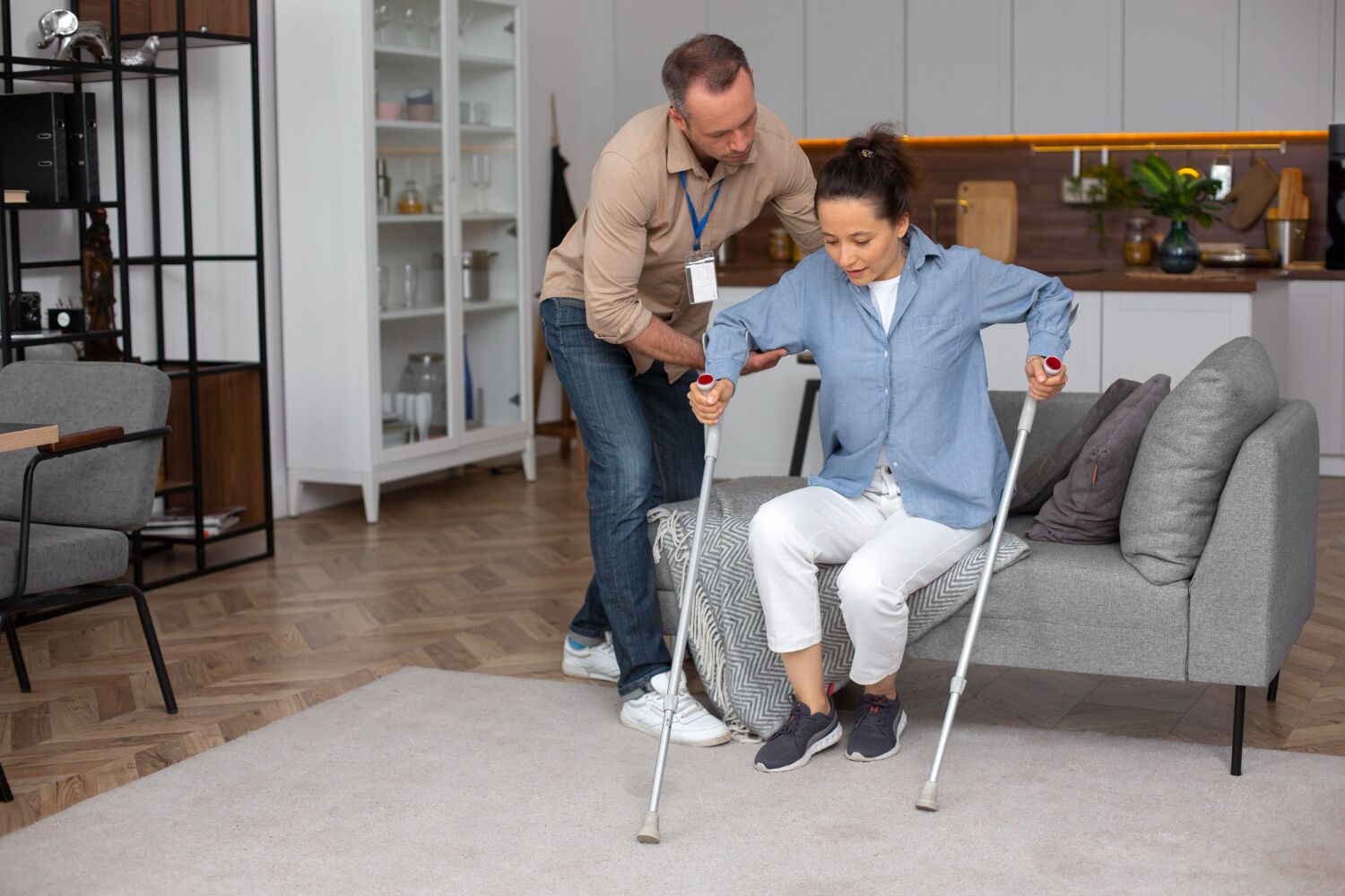 Patient assisted by healthcare professional with crutches, highlighting the importance of finding the right pain management specialist covered by BlueCross BlueShield insurance.